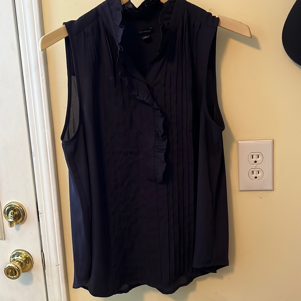 Navy sleeveless half button blouse.100% polyester.